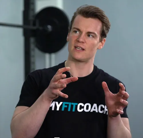 Dr. Tim Würth, Gründer von MyFitCoach, im schwarzen MyFitCoach-T-Shirt im Fitnessstudio