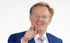 Dirk-Michael Lambert lächelt und zeigt mit dem Finger in die Kamera